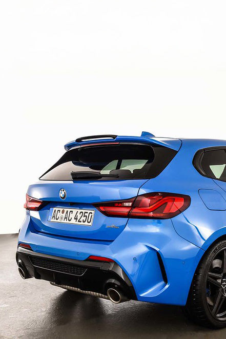 Blue BMW car shown from the rear with an AC Schnitzer spoiler on a white background