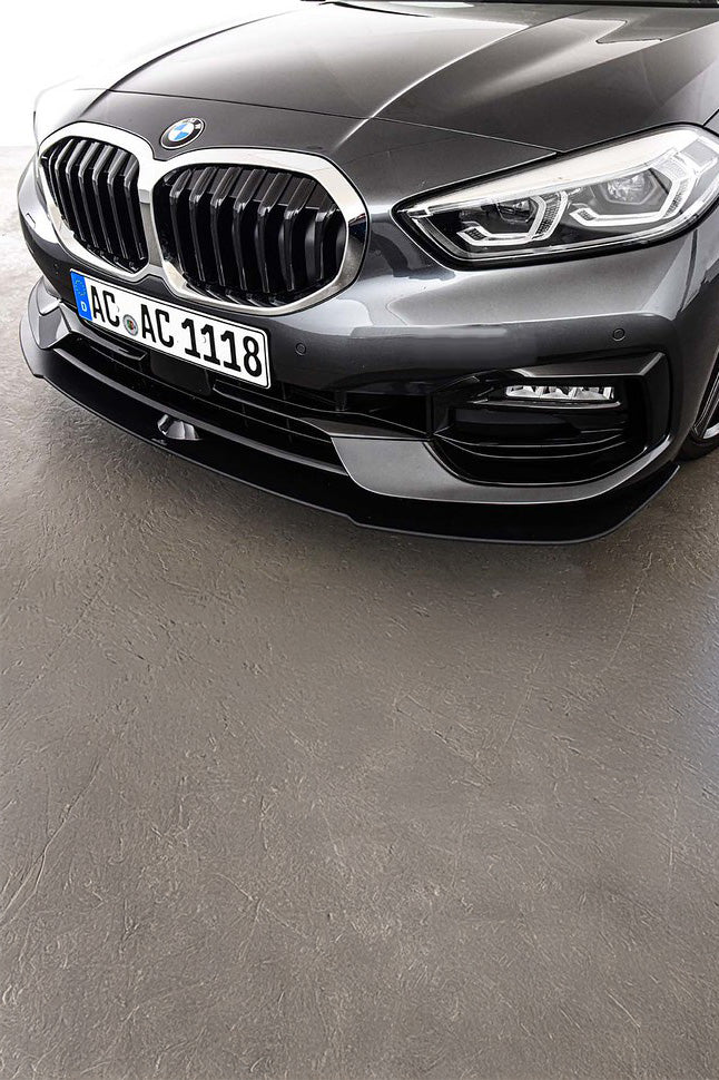 Front view of a BMW car with an AC Schnitzer Front Splitter on a grey surface