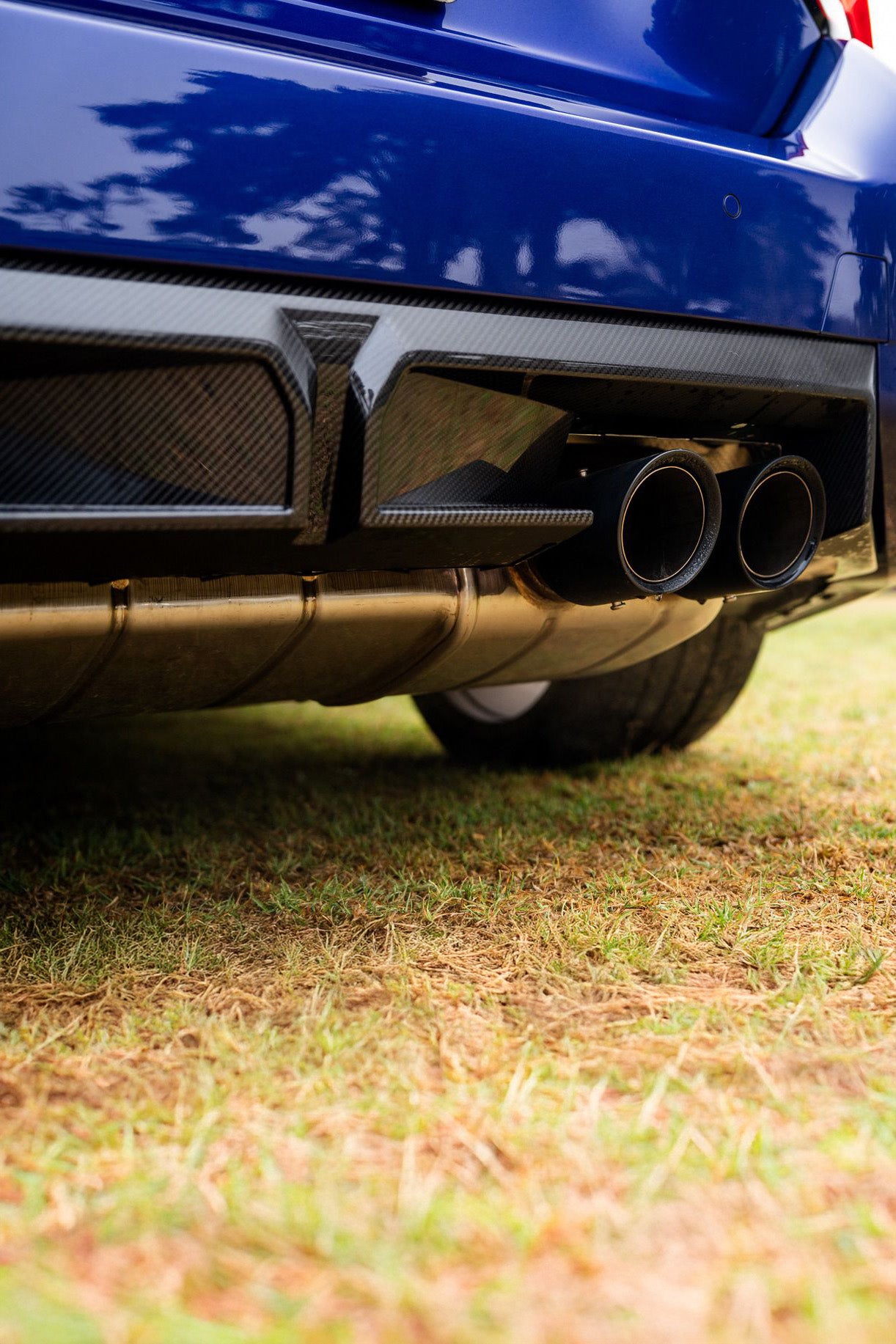 Close-up of an M2's exhaust system on grass