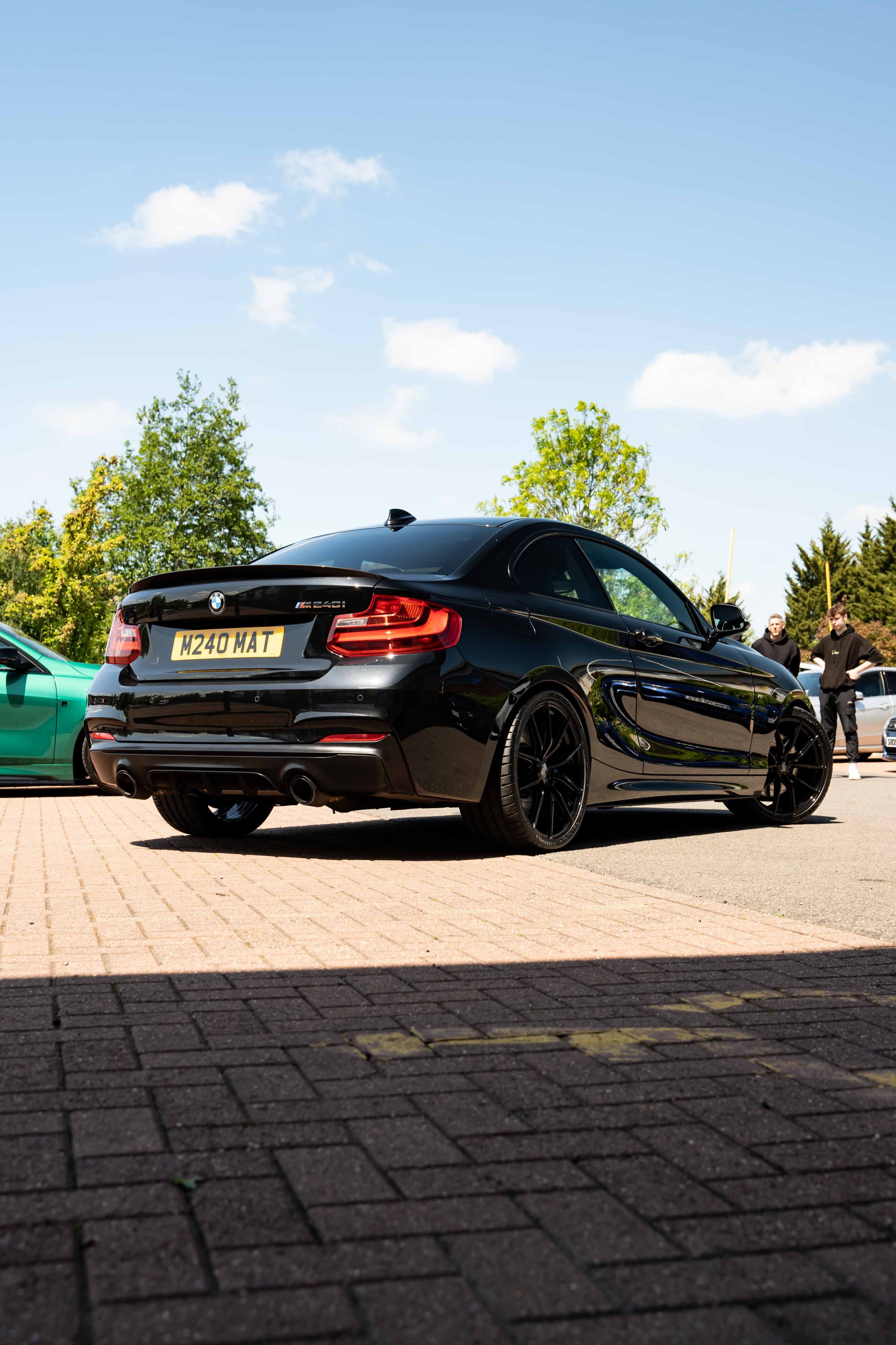 Black BMW on Motech Stance springs with clear skies above it.