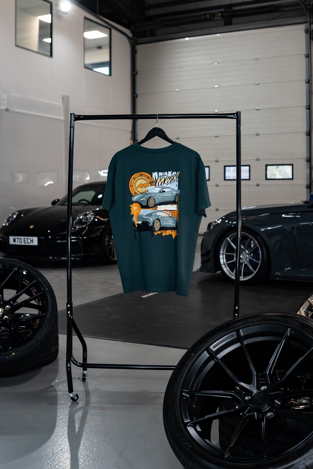 Vantage Collection Buckinghamshire Green Oversized T-shirt with car graphic on a rack in a garage setting
