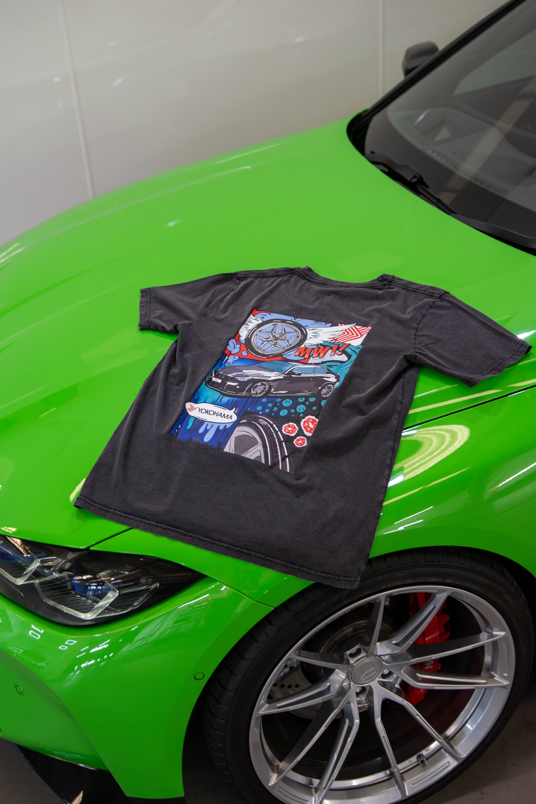 Treadlight Collection Stone Washed T-Shirt with a colorful graphic design on a green car