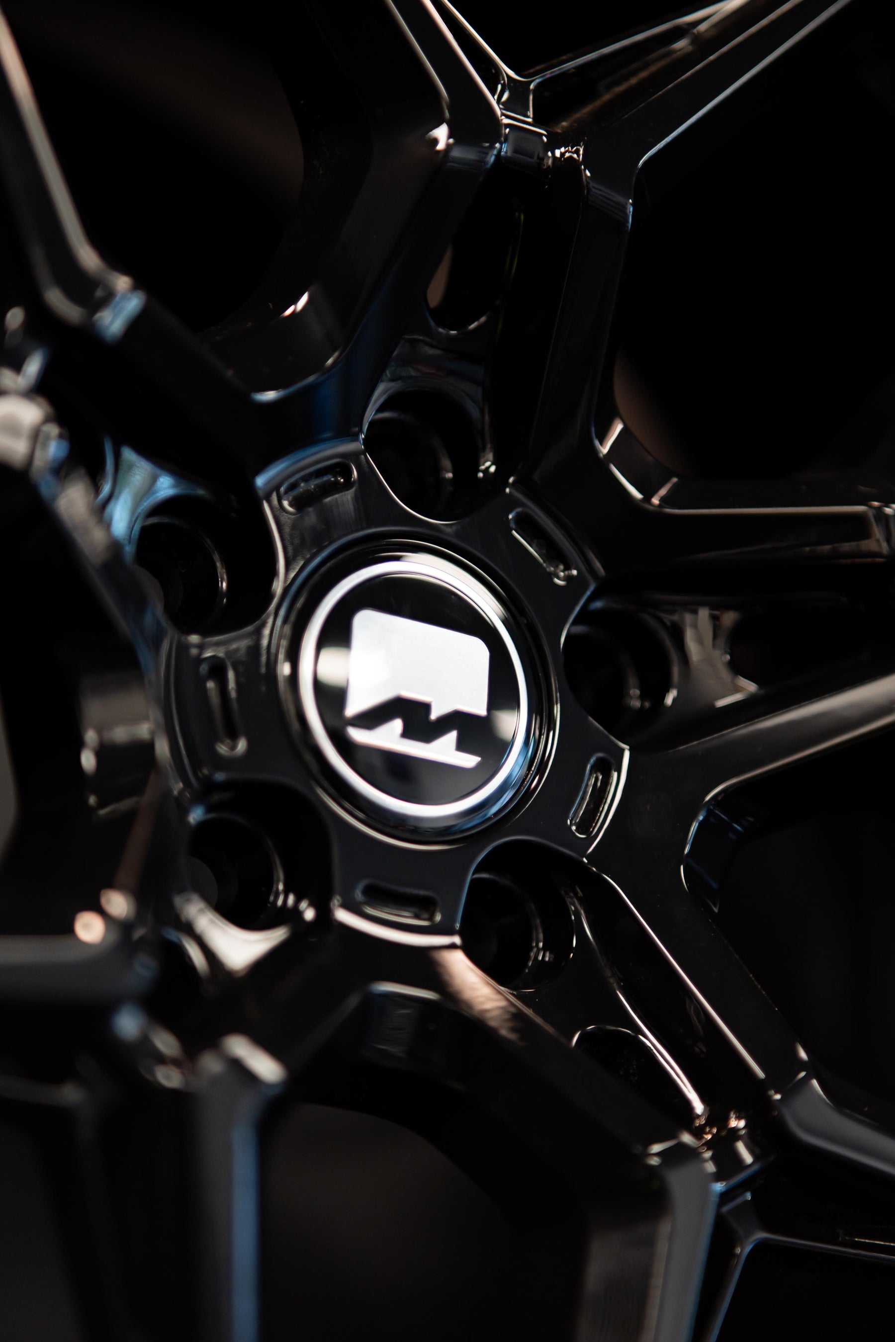Close-up of the centre-cap on a Precision Black M-W1 wheel.