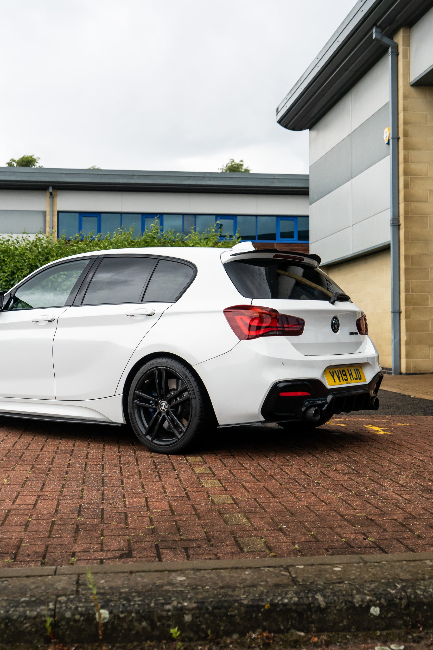 The back of a white BMW 1 Series with Motech stance springs.