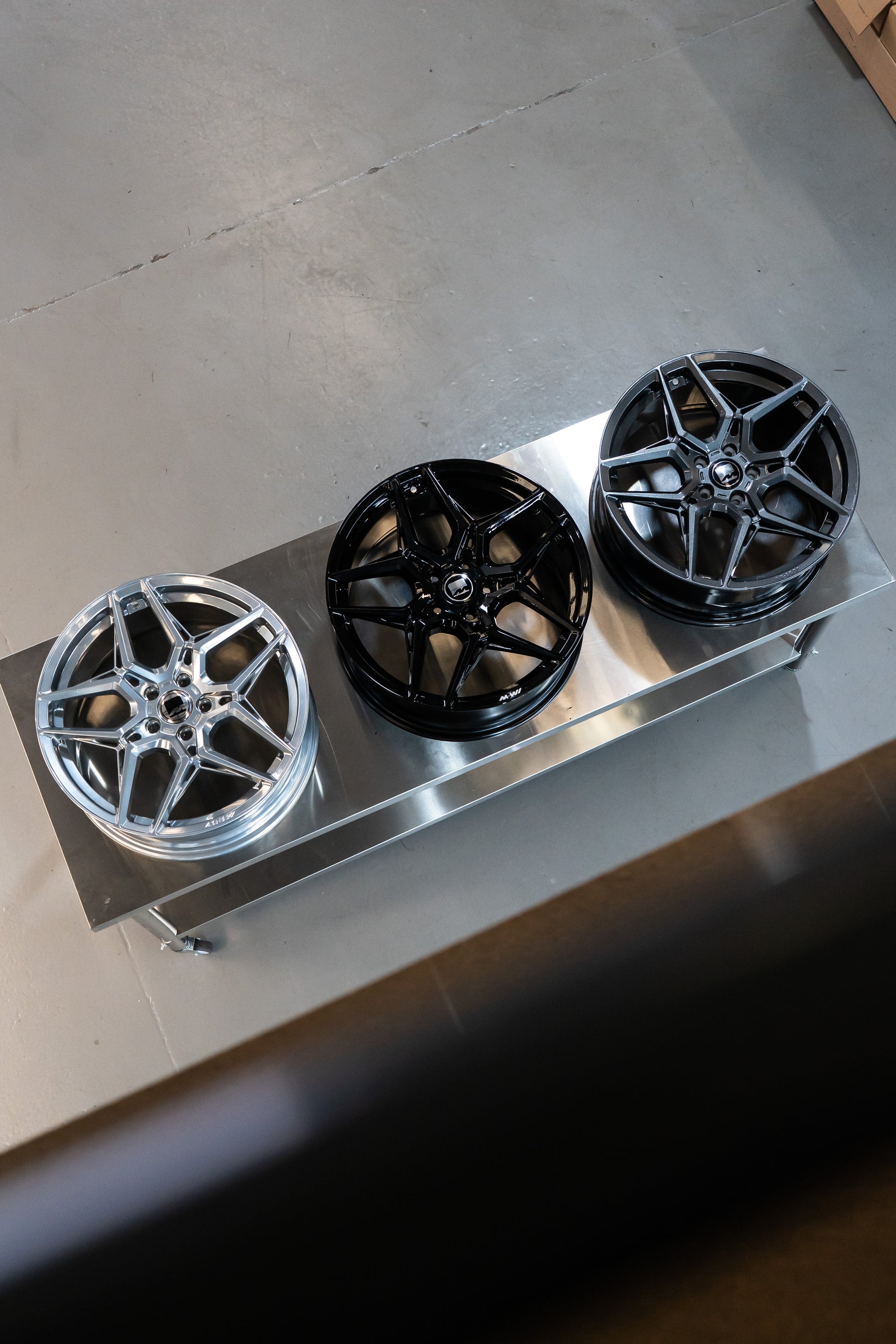 3 Motech M-W1 wheels, one in gloss polished, one in precision black, one in carbon grey