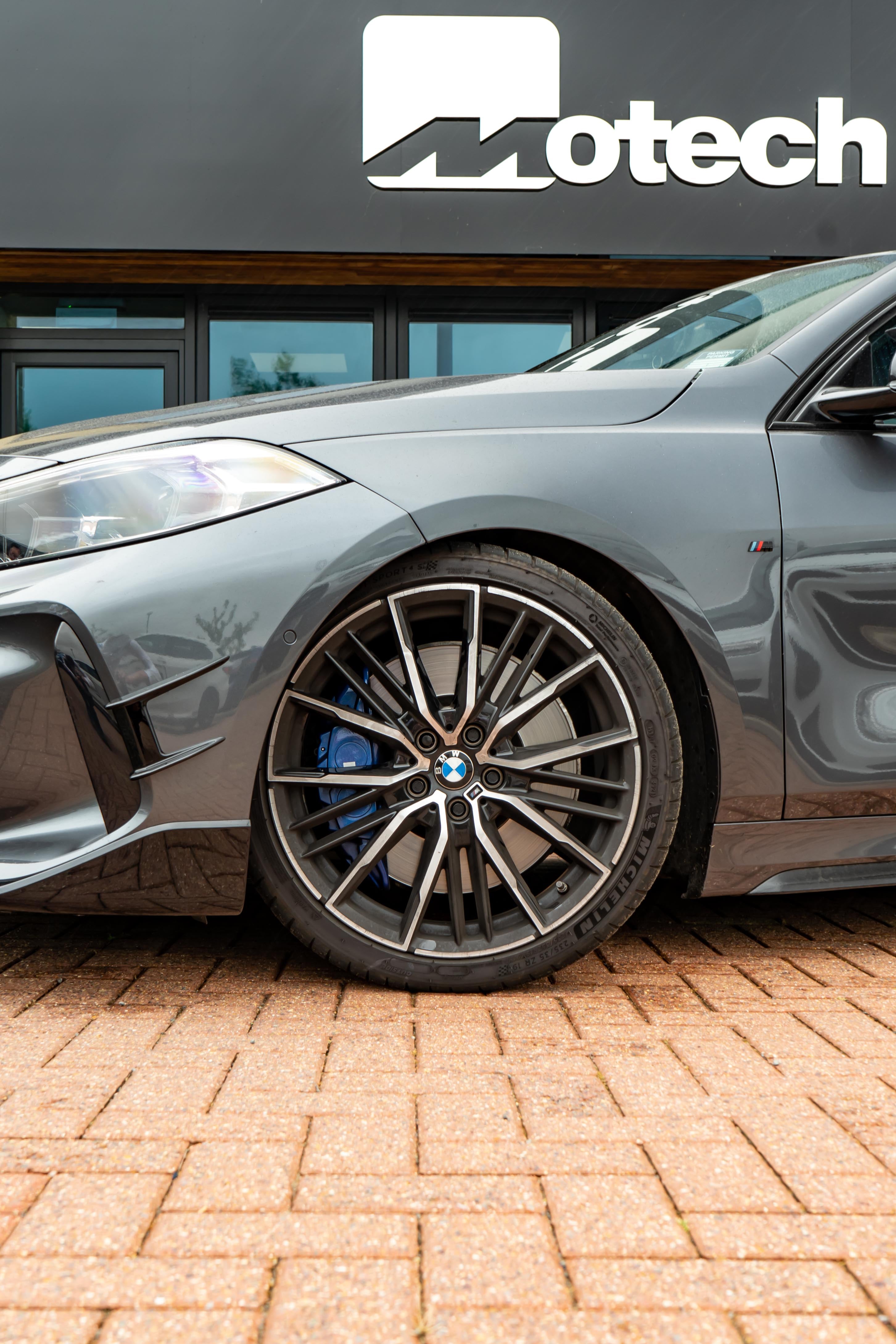 Silver BMW car with Motech branding in the background