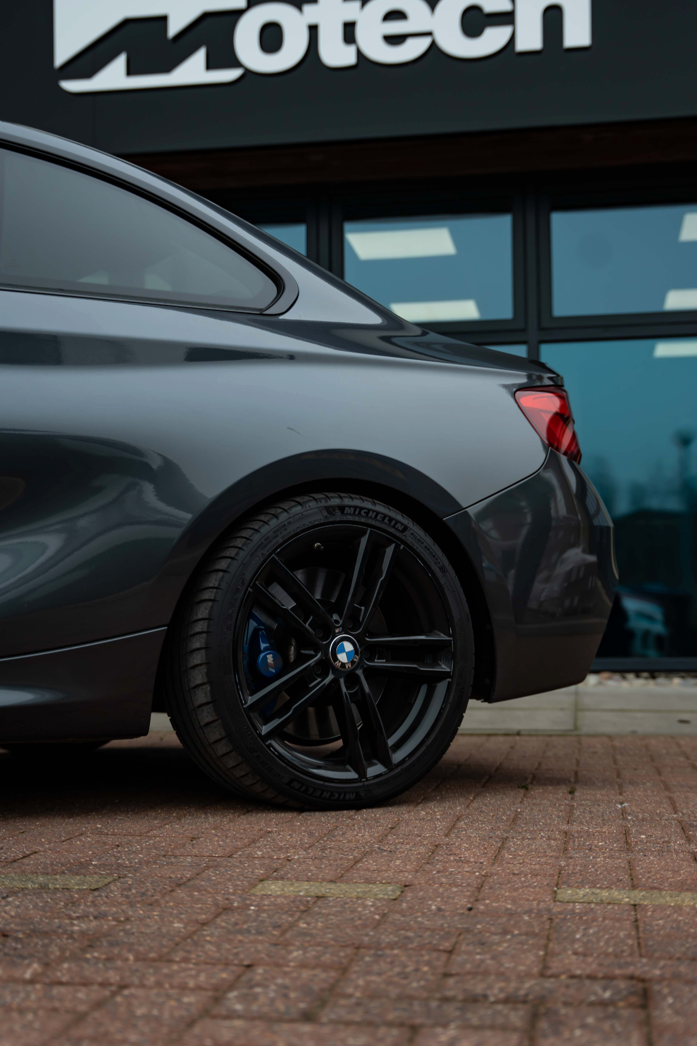 BMW Car with black wheels and Motech branding in the background