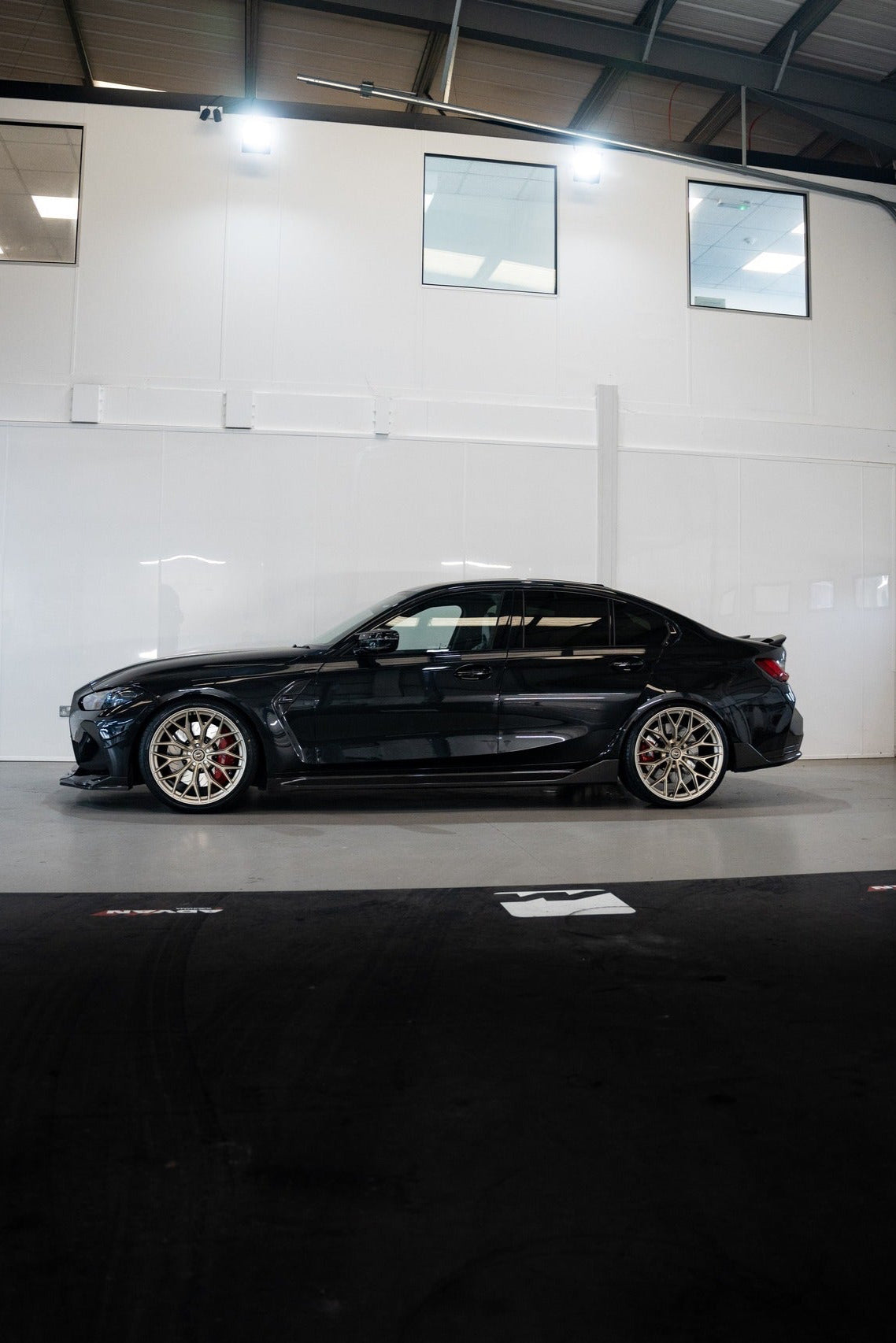Black BMW with Motech Wheels lowered on Springs.