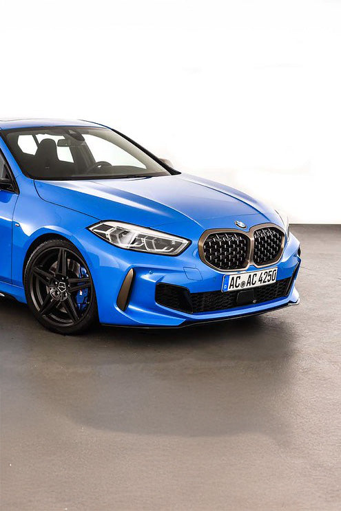 Blue BMW car with an AC Schnitzer Front Splitter on a grey floor with a white background