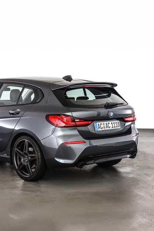 Grey BMW car parked on a concrete floor with an AC Schnitzer spoiler