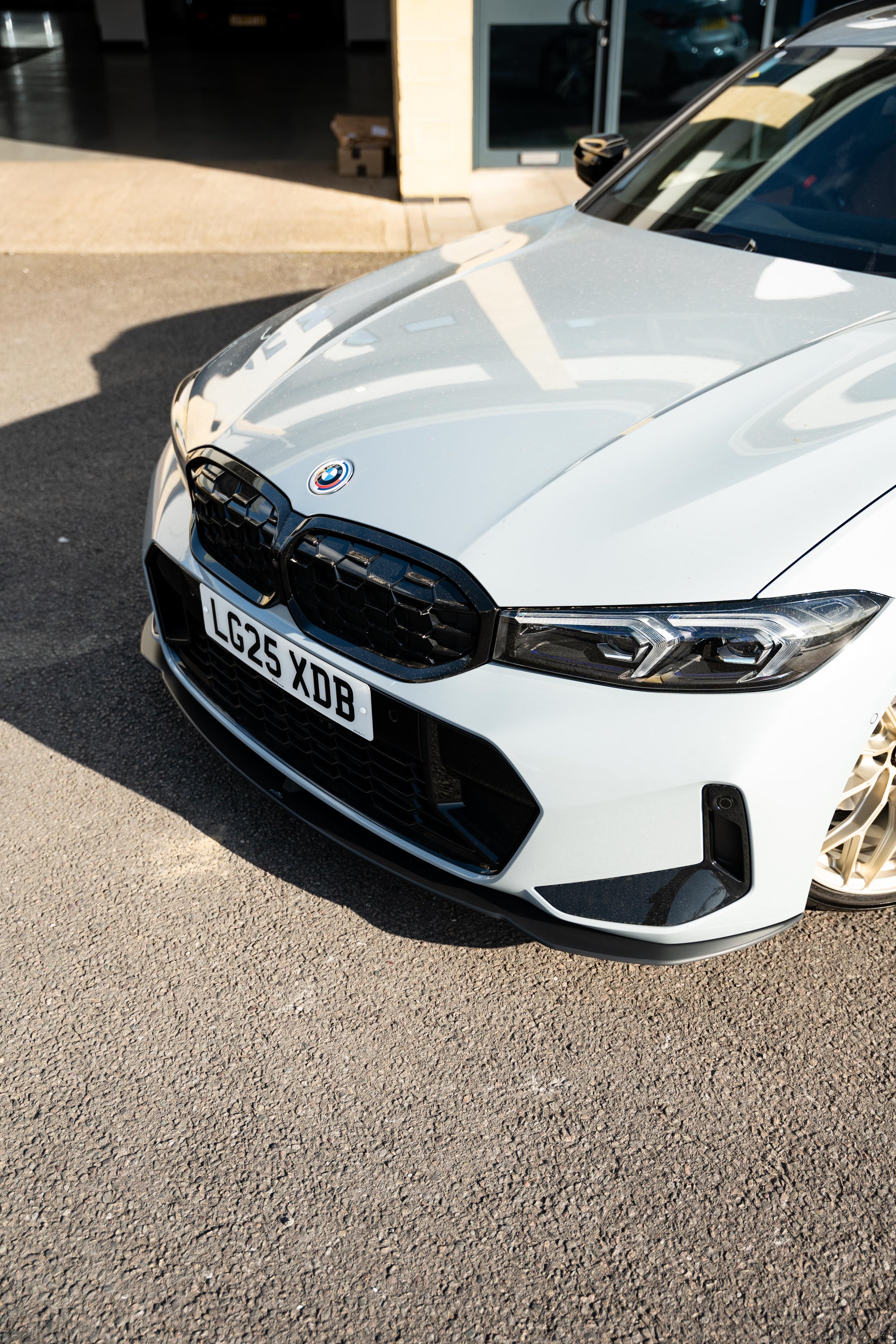 New Grey BMW 3 Series with an aftermarket AC Schnitzer Front Splitter attached.