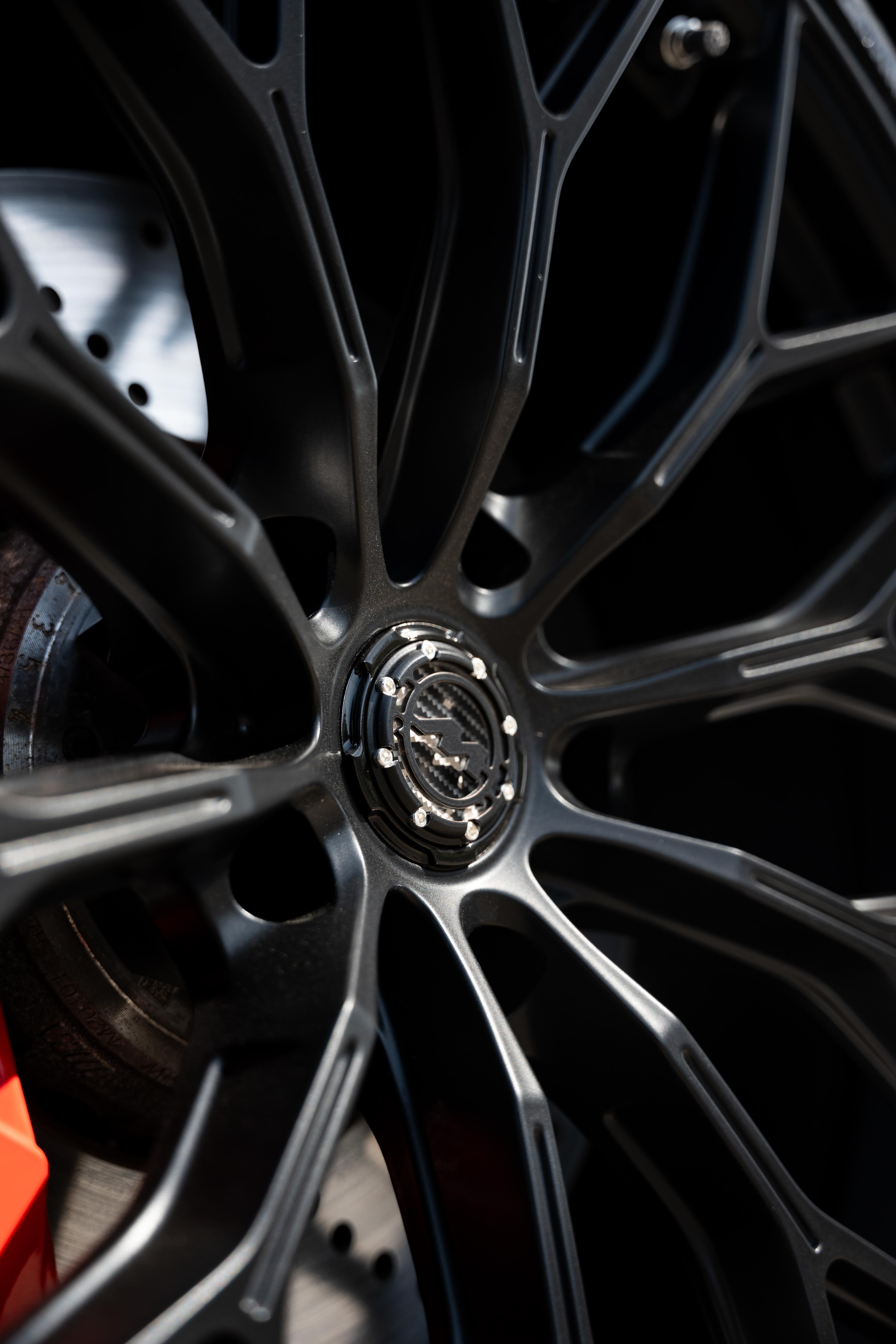 Close-up of a black Motech M-WX wheel with a black Motech centre-cap.