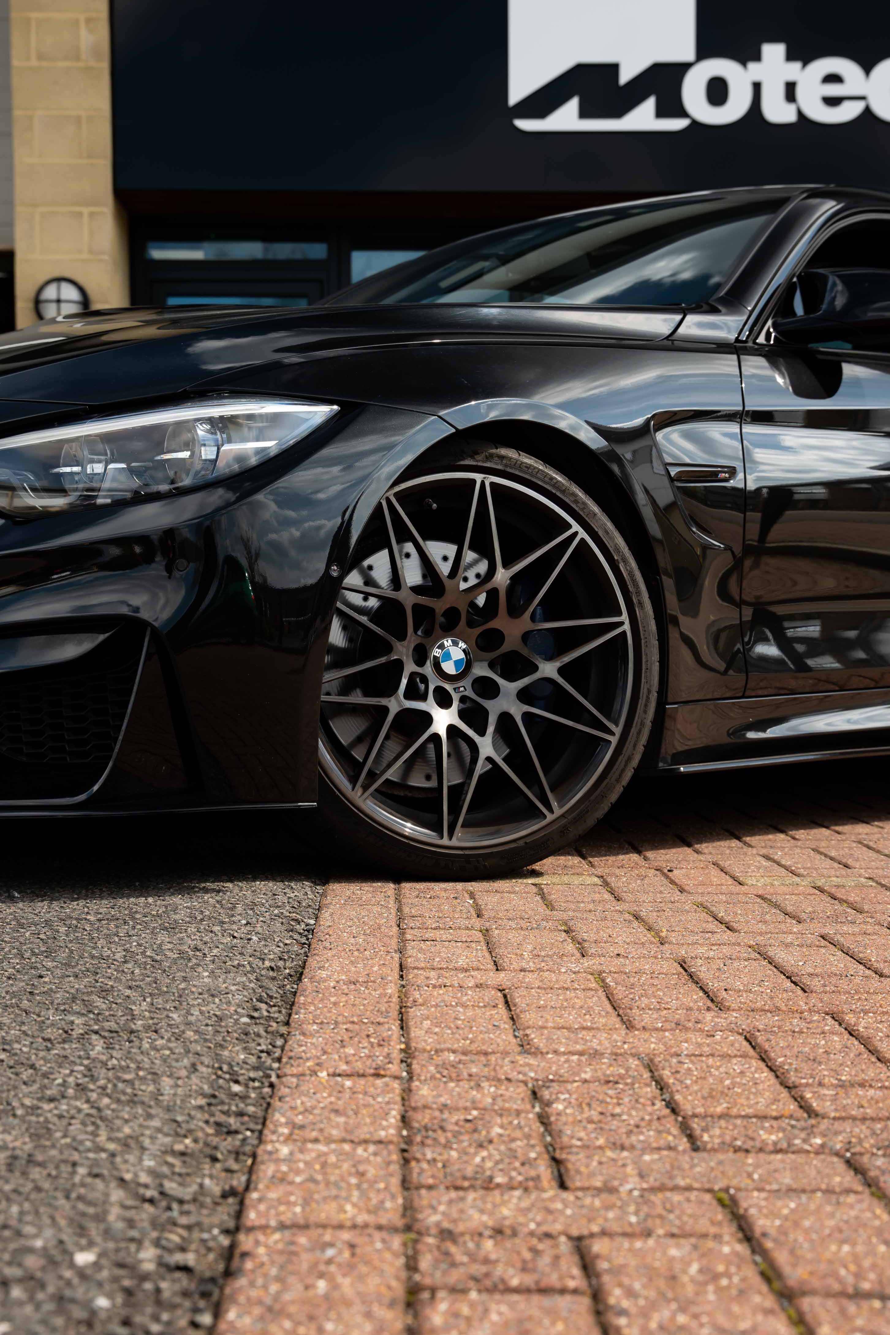 Close-up shot of the front of a Black BMW on Motech Stance Springs