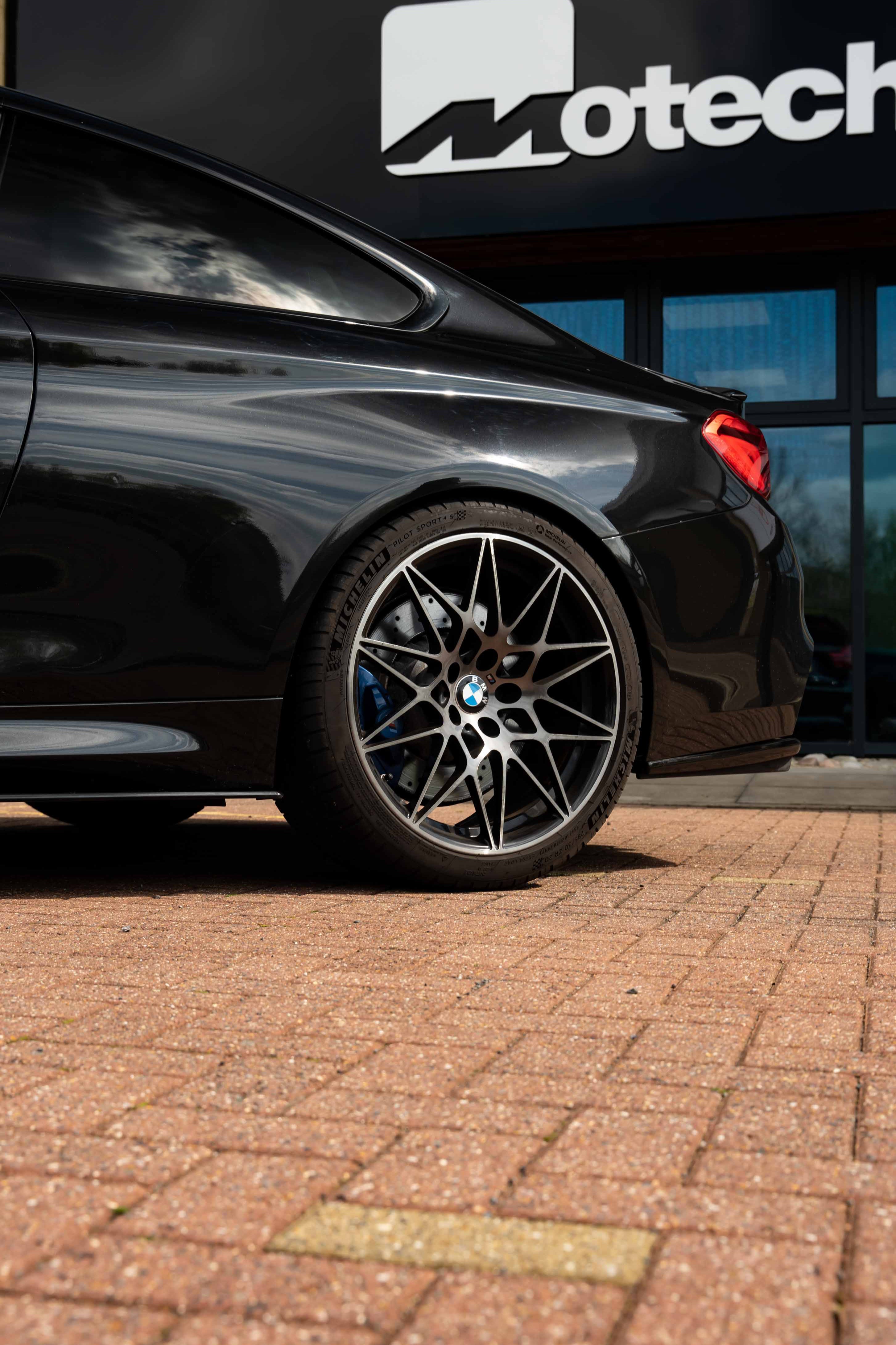 Close-up shot of the back of a black BMW on Motech Stance Springs