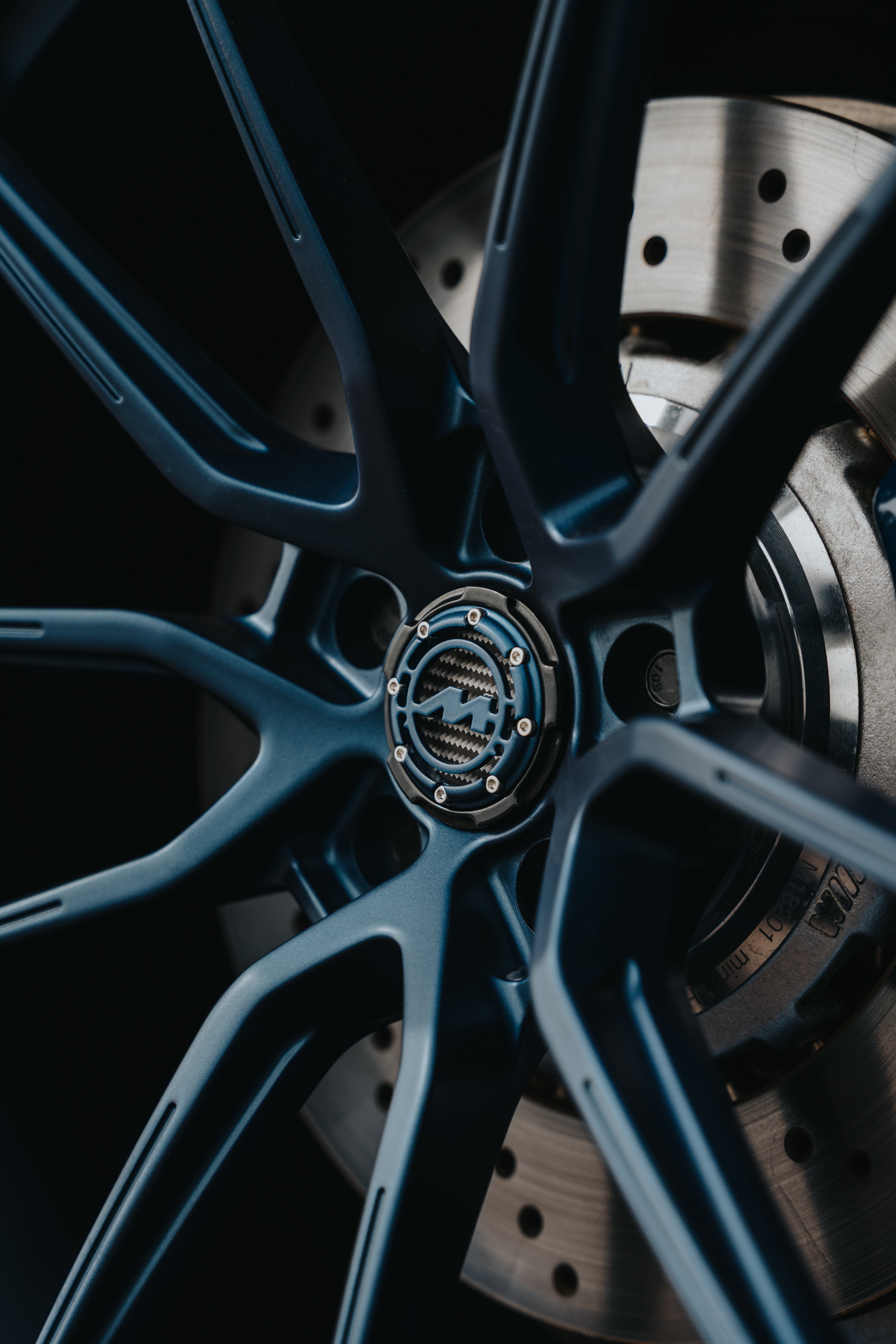Close up of a Satin Blue Motech wheel with a Satin Blue Centre Cap.