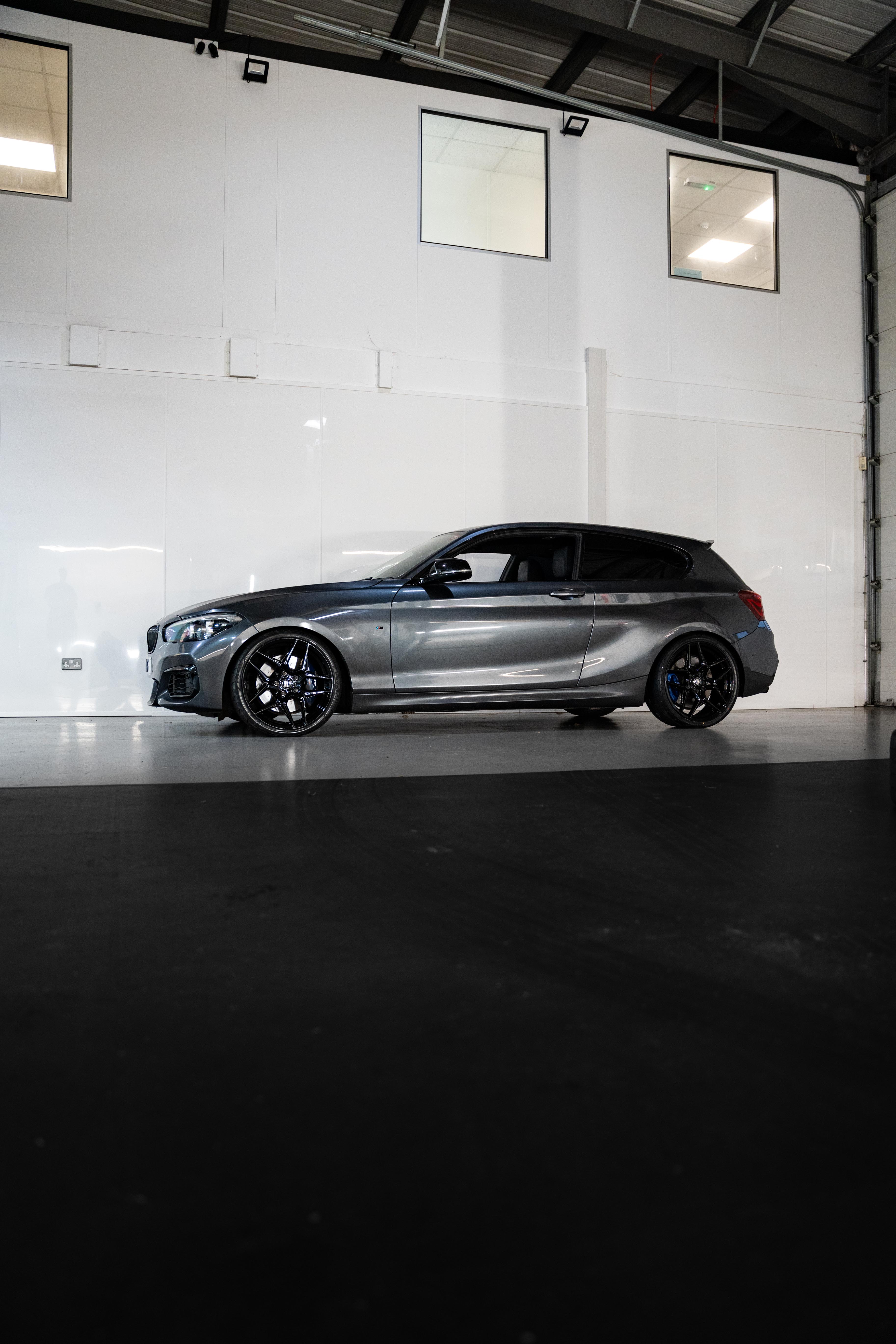 Side-on shot of a silver BMW on Motech Stance Springs in a workshop.