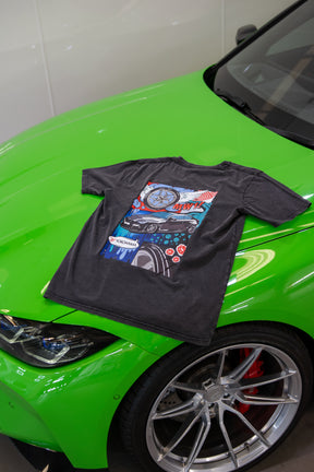 Treadlight Collection Stone Washed T-Shirt with a colorful graphic design on a green car