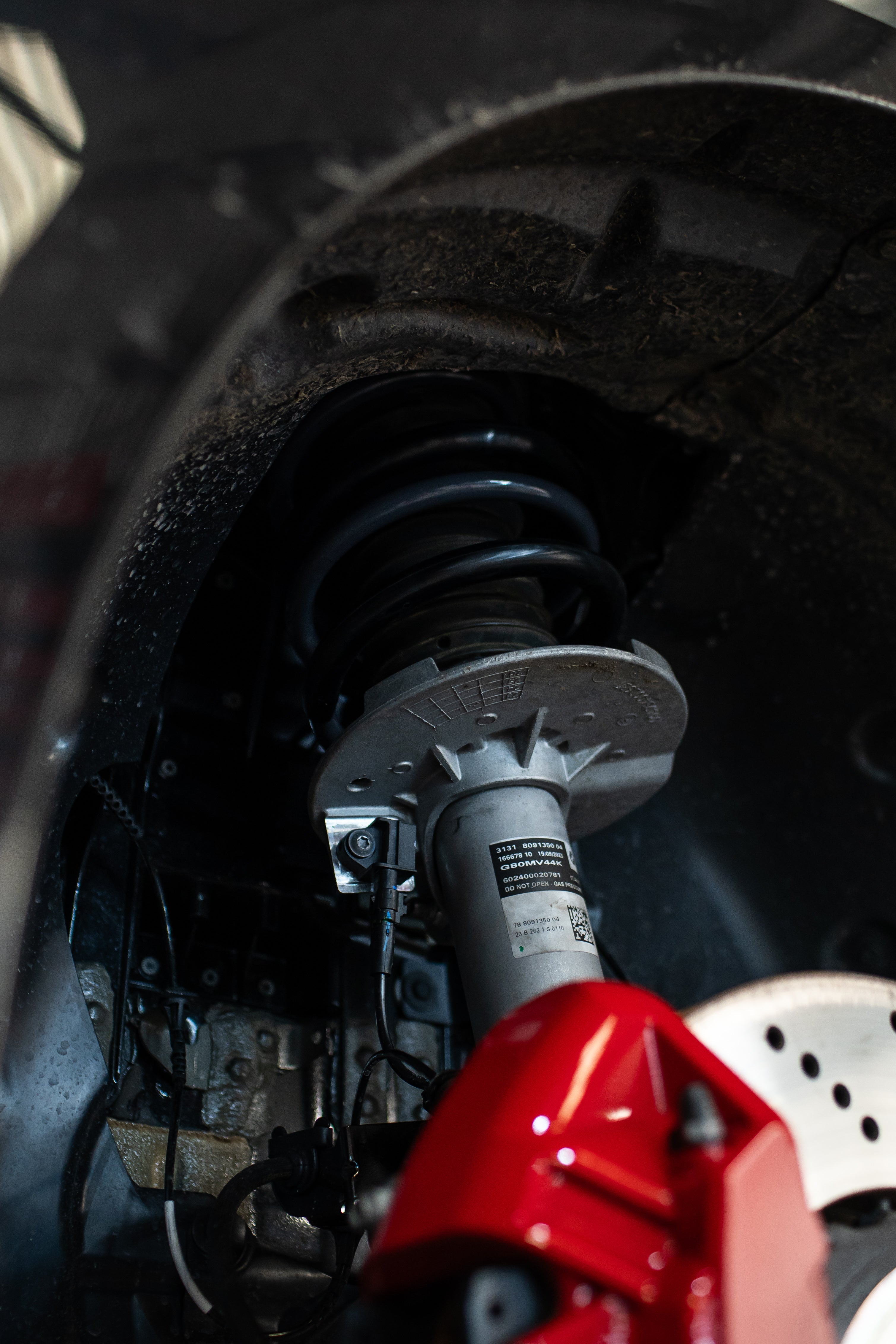 Close-up of Motech Stance springs being fitted to car.