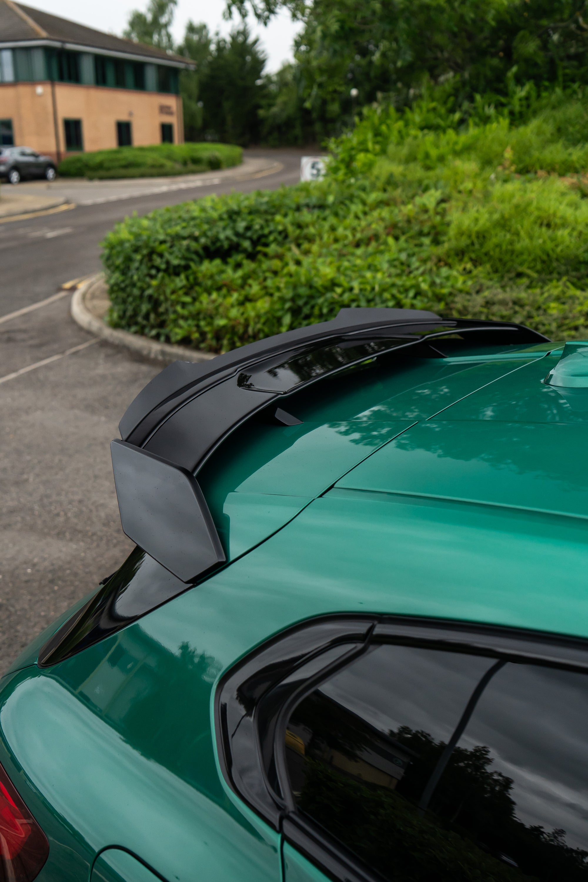Green Car with an aftermarket Maxton Design Spoiler